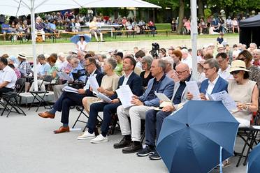 Jahresfest 2025 – Festgottesdienst – Besucher*innen sitzen vor der Bühne im Schlosspark.